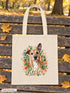 Visuel d’illustration – tote bag posé sur un banc en bois dans un parc en automne, avec le portrait à l’aquarelle d’Hector, chien fictif, et son prénom