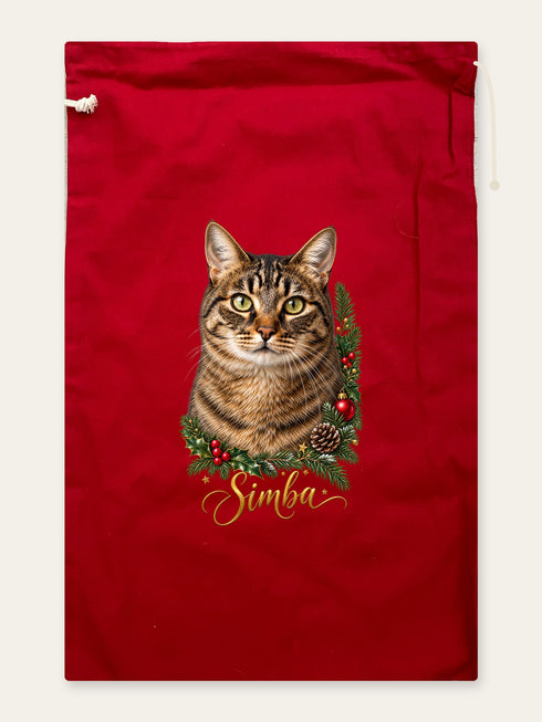Visuel d’illustration – hotte de Noël en coton rouge cerise, 40 × 62 cm, à plat, vue de face, avec le portrait de Simba, un chat tigré, style Couronne de Noël, prénom en lettres dorées