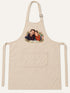 Visuel d’illustration – tablier de cuisine crème en coton, à plat, vue de face, avec un portrait de couple fictif en style Portrait signature, prénoms « Camille & Hugo »