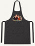 Visuel d’illustration – tablier de cuisine noir en coton, à plat, vue de face, avec un portrait de couple fictif en style Portrait signature, prénoms clairs « Camille & Hugo »