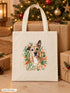 Visuel d’illustration – tote bag au pied d’un sapin de Noël, entre des paquets kraft, avec le portrait à l’aquarelle d’Hector, chien fictif, et son prénom