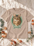 T-shirt enfant sable personnalisé avec le portrait Cercle illustré détouré de Simba, sur un décor en lin et fleurs séchées.