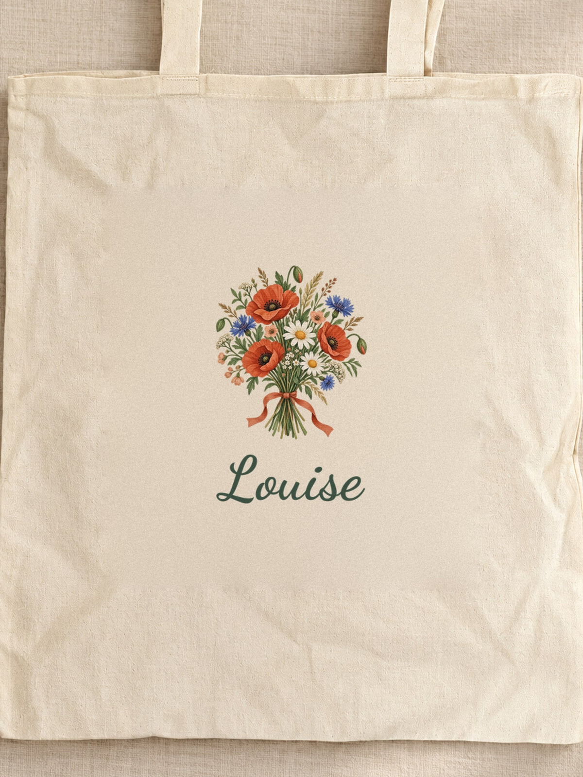 Visuel d’illustration – tote bag au prénom Anaïs posé sur une table en chêne avec des fleurs