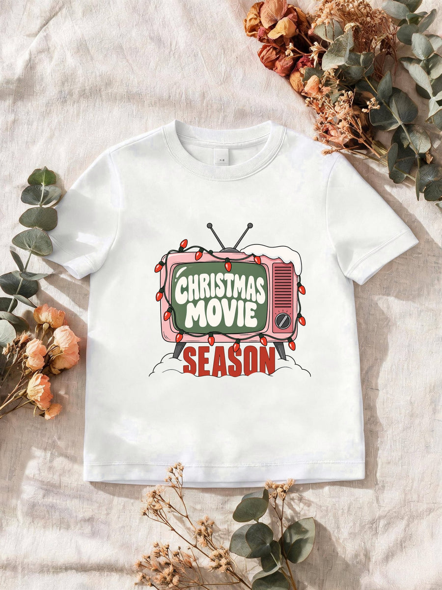 Visuel d’illustration – T-shirt homme blanc avec la télé rétro rose et sa guirlande, « Christmas Movie Season »