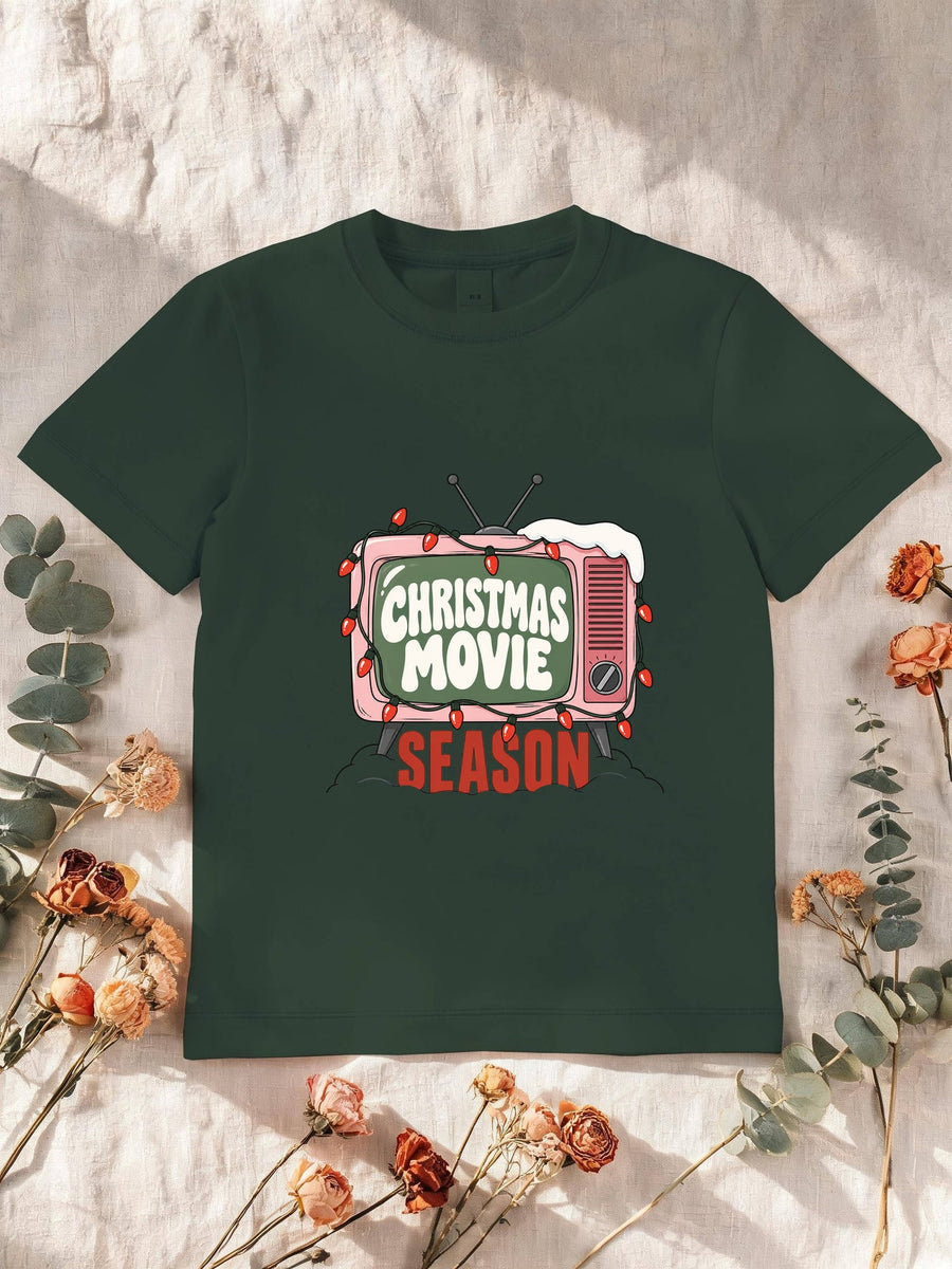 Visuel d’illustration – T-shirt enfant vert forêt avec la télé rétro rose et sa guirlande, « Christmas Movie Season »